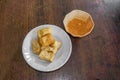 Top view Chinese snack and vegetarian food `Fried Tofu` on white ceramic plate and peanut sweet and sour spicy sauce