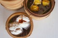 Top view of Chinese steamed red pork bun break can see pork inside and Cantonese Shumai Siu Mai wrap by yellow wonton wrapper Royalty Free Stock Photo