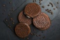 Top view of chocolate biscuits, coffee beans on the black table. Coffee and chocolate taste