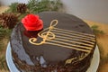 Top View Of A Chocolate Cake With A Stylized Image Of A Musical Staff Stave With A G-Clef And A Red Rose On A Wooden Background Royalty Free Stock Photo