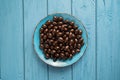 TOP VIEW: Chocolate candies on a blue bowl on blue table