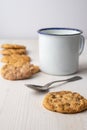 Top view of chocolate chip cookie with white cup and spoon, with selective focus, on white background Royalty Free Stock Photo