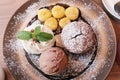 Top view, A Chocolate muffin served with chocolate ice cream, whipped cream and banana, that`s topped with caramel syrup. Royalty Free Stock Photo