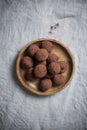 Top view of chocolate round truffles in a wooden bowl on the table. Dessert Royalty Free Stock Photo