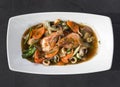 Top view of Chop Suey with shrimp and squid rings on a white plate