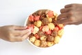 Top view chrildren eating colorful popcorn in bowl  on white background. Royalty Free Stock Photo