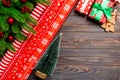 Top view of Christmas background made of fir tree, rolled wrapping paper and other decorations on wooden background. New year Royalty Free Stock Photo