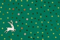 Top view of Christmas background made golden decorations, confetti, snowflakes and deer figure made of wood on green Royalty Free Stock Photo