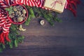 Top view of christmas decoration - red bowl full of fir-cones, gift box wrapped in kraft paper, golden angel, pine branches, candl Royalty Free Stock Photo