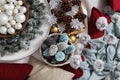 Top view christmas decorations centerpiece with garland and balls near a basket with colorful pine cones, isolated on a white