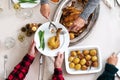 Top view of Christmas dinner table. Caucasian woman serving chicken to her son. Family holiday gathering. Royalty Free Stock Photo