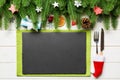 Top view of Christmas dinner on wooden background. Plate, utensil, fir tree and holiday decorations with copy space. New Year time Royalty Free Stock Photo