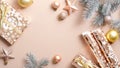 Top view Christmas frame with elegant decorations on pastel beige background. Flat lay Xmas balls, stars, Christmas tree branches Royalty Free Stock Photo