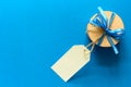 Top view on Christmas gift box decorated with ribbon on blue paper background. Royalty Free Stock Photo