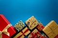 Top view on Christmas gifts wrapped in gift paper decorated with ribbon on blue paper background. Royalty Free Stock Photo