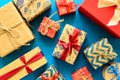 Top view on Christmas gifts wrapped in gift paper decorated with ribbon on blue paper background. Royalty Free Stock Photo