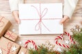 Top view of christmas letter in hand. Close up of hands holding empty wishlist on wooden table with xmas decoration Royalty Free Stock Photo
