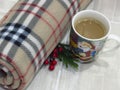 Top view. Christmas and New Year composition. Warm woolen winter blanket and Santa Claus cup of hot chocolate / cocoa.