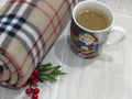 Top view. Christmas and New Year composition. Warm woolen winter blanket and Santa Claus cup of hot chocolate / cocoa.