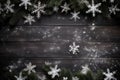 Top view Christmas snowflakes, fir tree branches on wooden black background. Royalty Free Stock Photo