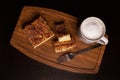 Top view of Churro Cheesecake Pieces and White Mug on a Wooden Base