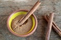 Top view cinnamon sticks and powder in bowl on wooden table Royalty Free Stock Photo