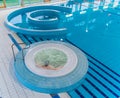 Top view of a circle indoor jacuzzi in a swimming pool complex with one unrecognizable caucasian person sitting in it