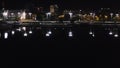 Top view of city dam with water at night. Stock footage. Beautiful view of city bridge with dark water reflecting lights