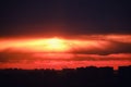 Top view of the city at dusk. Setting night sun behind the silhouettes of houses. Nightfall in the big city Royalty Free Stock Photo