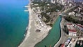 Top view of city located on coast. Clip. Beautiful coast with turquoise water and channel running from coast to city Royalty Free Stock Photo