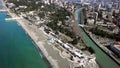 Top view of city located on coast. Clip. Beautiful coast with turquoise water and channel running from coast to city Royalty Free Stock Photo