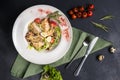 Top view on classic Caesar salad with grilled chicken breast and half of quail eggs in white ceramic plate. Green tablecloth, Royalty Free Stock Photo