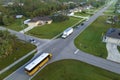 Top view of classical american yellow school bus picking up kids at rural town street stop for their lessongs in early Royalty Free Stock Photo