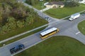 Top view of classical american yellow school bus picking up kids at rural town street stop for their lessongs in early Royalty Free Stock Photo