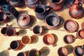 Top view of the clay dishes. Handmade products in the pottery workshop. Pots, jugs, mugs, goblets and vases of burnt ceramics