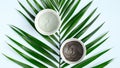 Top view clay masks and tropical leaf. Natural SPA cosmetics for skincare, body and hair care concept