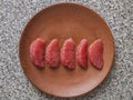 Top view of five pieces of peeled grapefruit