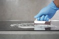 Top view Cleaning a ceramic electric stove with a metal scraper.