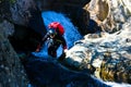 Top view of a climber with helmet and red backpack climbing rocks in church beck canyon in Coniston