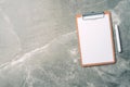 Top view of clipboard, paper, pen on marble background with copy space. Top view, copy space. Blogger, feminine business concept.