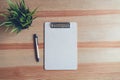 Top view clipboard with pen and white paper on the table background. Royalty Free Stock Photo