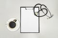 Top view clipboard, stethoscope and cup of coffee on white background