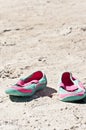 Female, sandles in the sand of a tropical beach