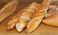 Variety of local, artisan produced loafs of bread on a wood shelf, at a Ft. Lauderdale, FL food show