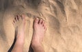 Top view, close up child`s feet on beach sand in summer, warm sunlight, space for copy and design. Horizontal image child`s Royalty Free Stock Photo