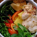 Close up dry paper noodles soup bowl, tofu, pine apple, tomato, water spinach Royalty Free Stock Photo