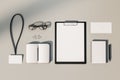 Top view and close up of empty office supplies on white desktop. Clipboard, notepad, bad, envelope. Mock up, 3D Rendering