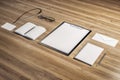 Top view and close up of empty office supplies on wooden desk. Clipboard, notepad, bad, envelope. Mock up
