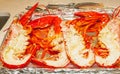 Four split and steamed, halved, north American lobsters, on tin foiled tray Royalty Free Stock Photo