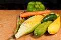 Ear of corn, with the husk pulled back, jalapeÃÂ±o, green bell peppers, green, yellow squash, and carrot Royalty Free Stock Photo